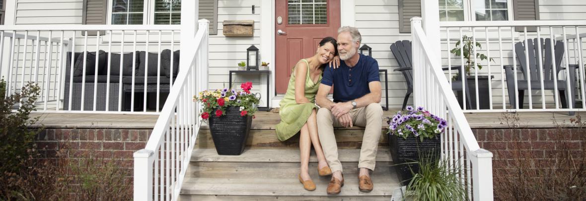 senior citizen couple sitting on porch