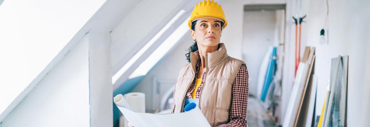 Woman studies chart during drywall installation
