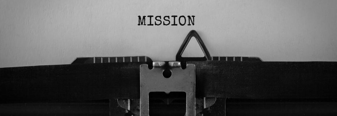 The word "mission" typed on old typewriter