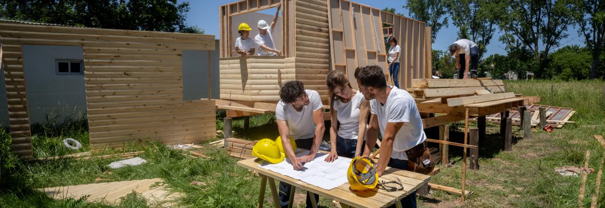 Workers building an affordable home on empty lot