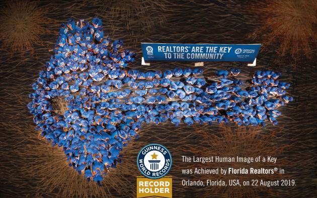 Overhead photo of Realtors standing in the shape of a key