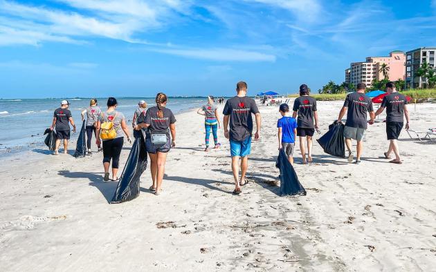 People on beach cleaning up litter