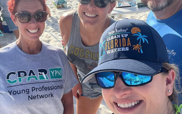 Selfie of four people on a beach