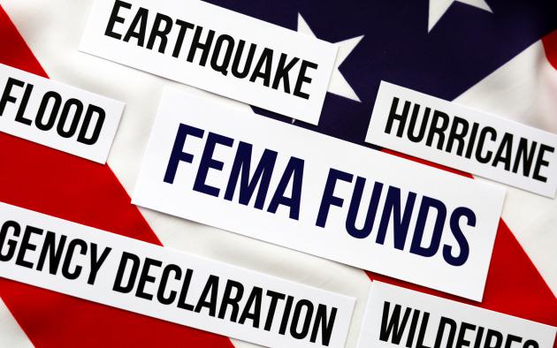 the words FEMA funds in a box appear on an American flag