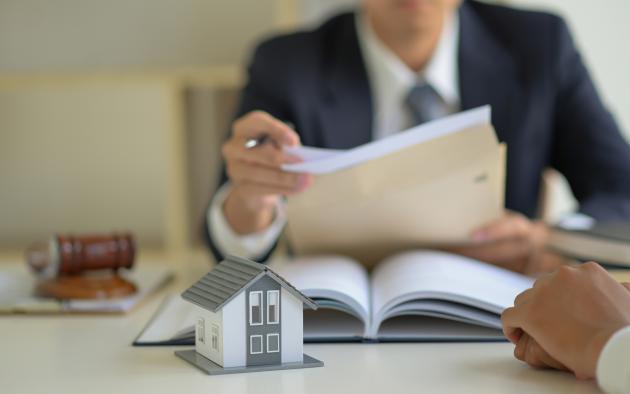 Closeup of photo a man holding paperwork at a desk