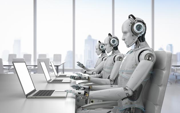 Line of robots sits in front of laptops with phones to their ears