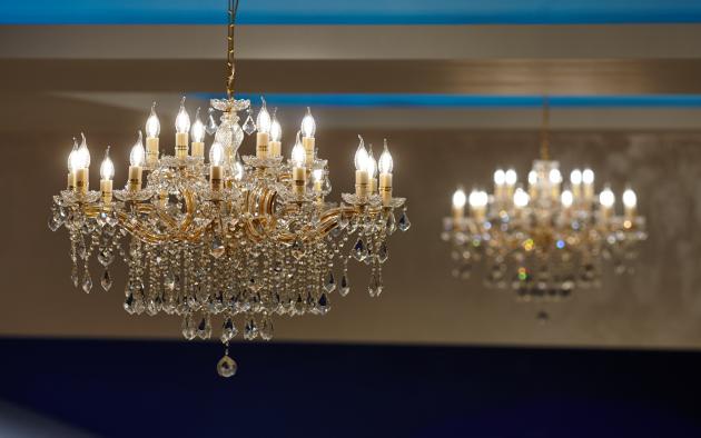 A large crystal chandelier with lights on