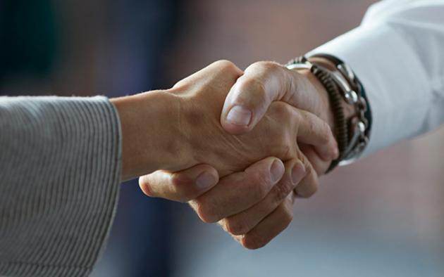 Photo of two business people shaking hands
