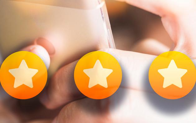 Photo of a person clicking 5 stars on her phone