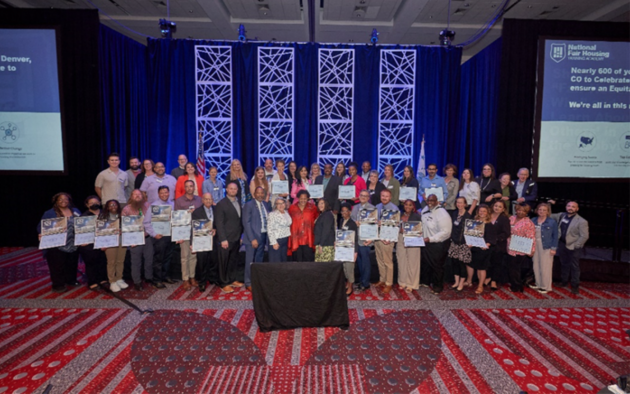 Large group photo of the fair housing groups representatives that will receive the latest HUD awards