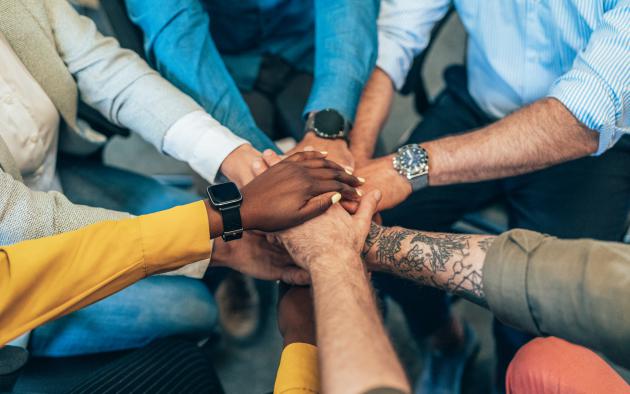 diverse hands in a circle