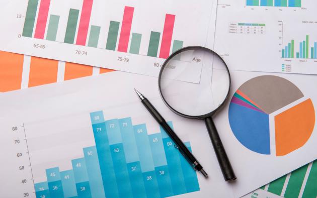 graphs and data with magnifying glass