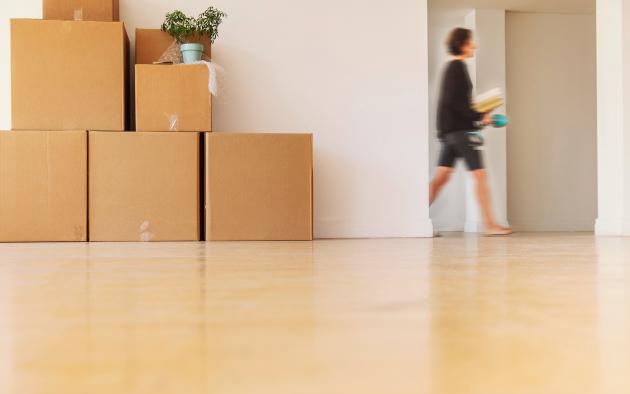 woman walking past doorway and moving boxes 