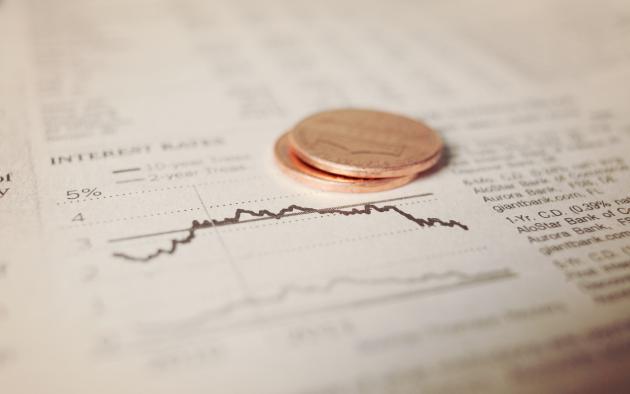 newspaper with coins interest rates