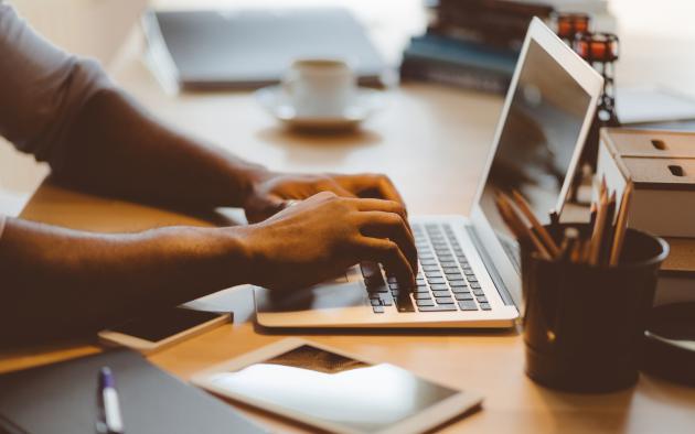 man typing on a computer