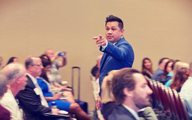 man speaking to convention-goers