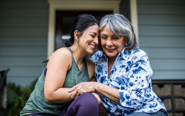 young woman and older woman hugging