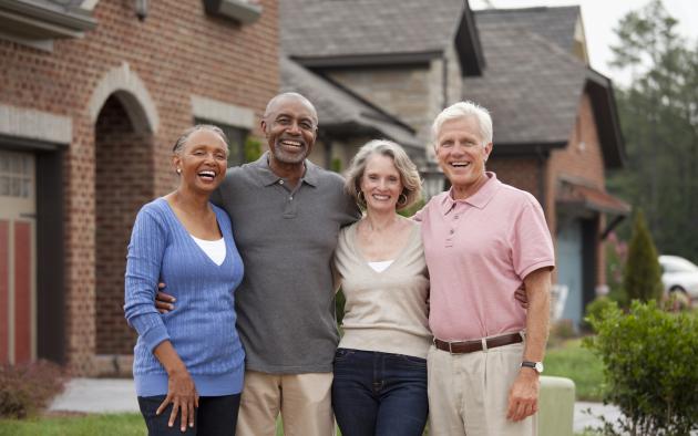 A black and white couple smile for a group photo