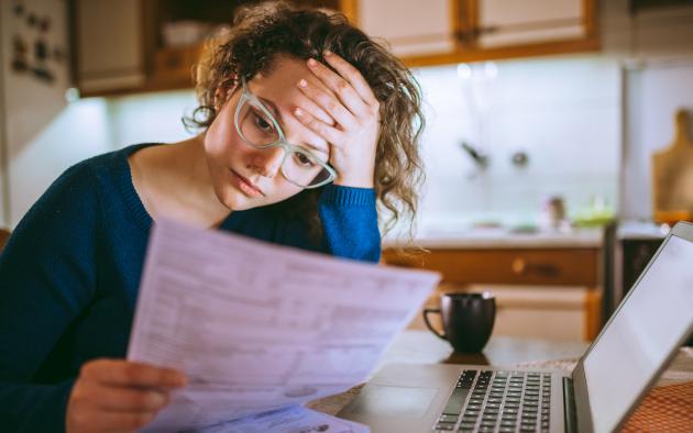 sad woman looking at bills
