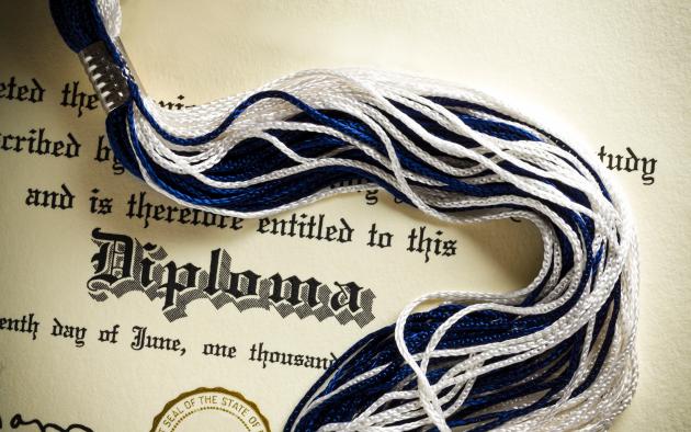 Graduation diploma with tassel across it