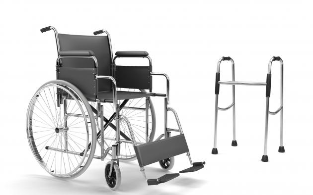Empty wheelchair beside a walker