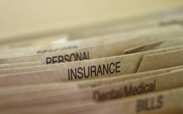 File folders with one for insurance in the middle