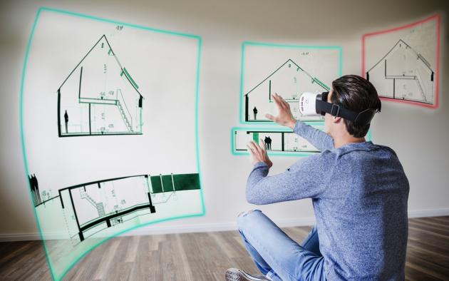 Man with 3D goggles stares at house plans