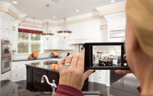 woman with camera in kitchen