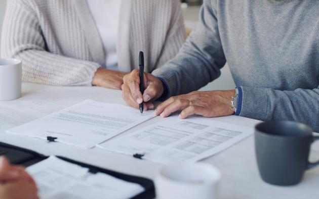 Man and woman signing contracts