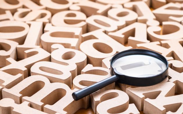magnifying glass with wooden letters