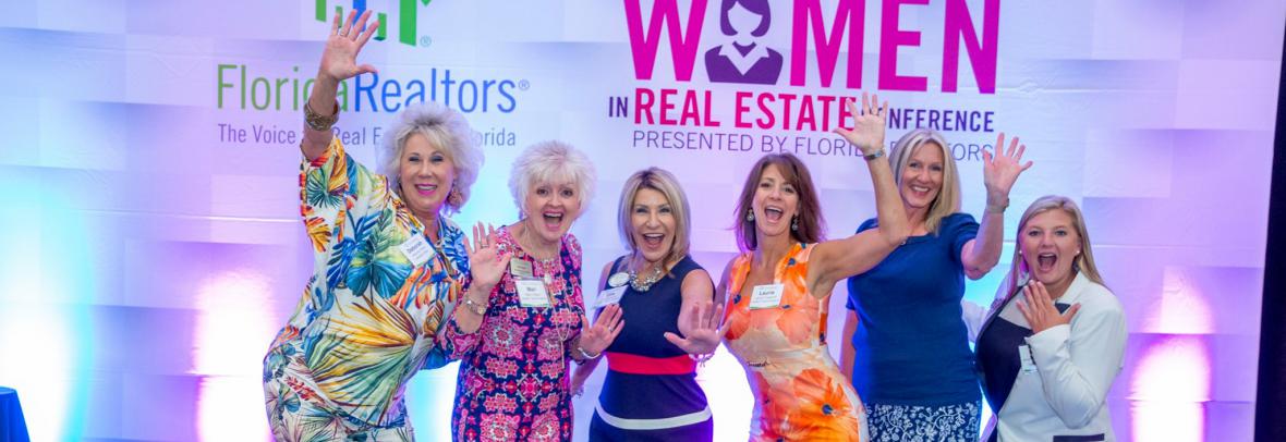 women in real estate conference attendees on stage