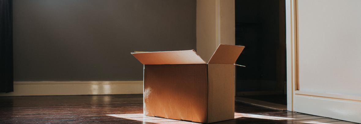 Cardboard box in empty room