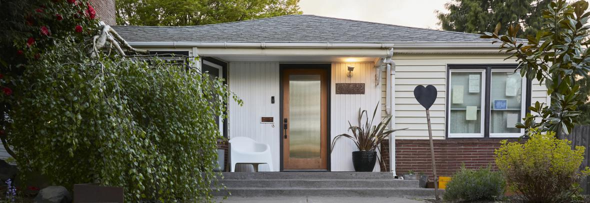 A small, white mid-century modern house
