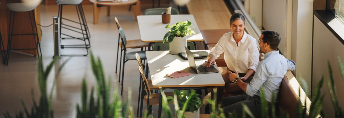 woman and man having project discussion in coworking office space