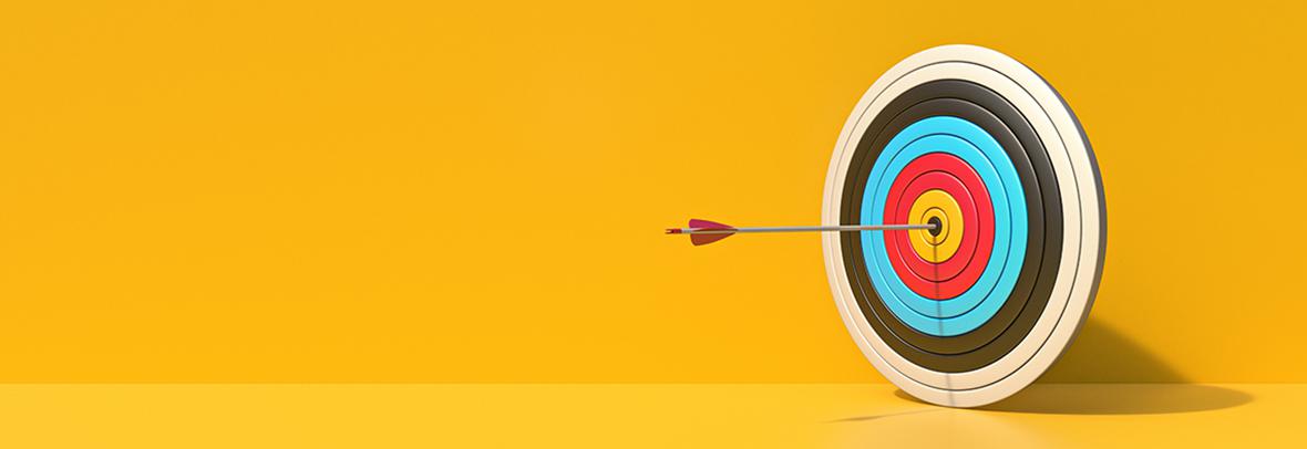 Photo illustration of a target with an arrow in it on a yellow background