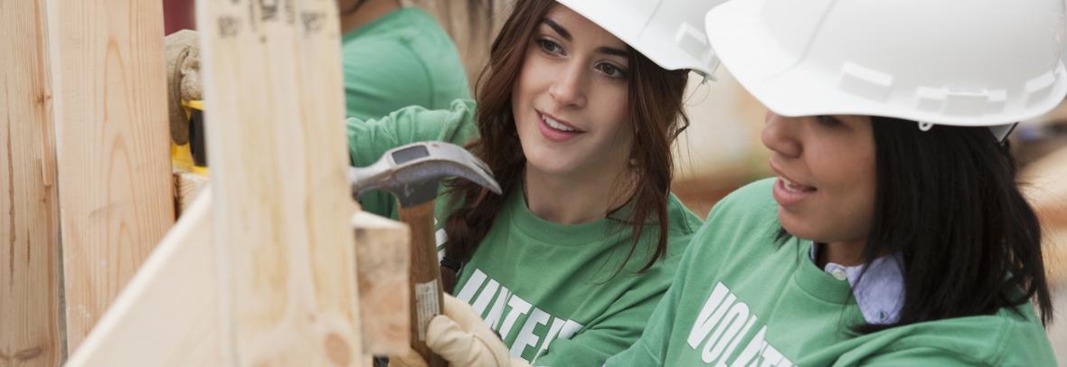 female volunteers working on a home construction site