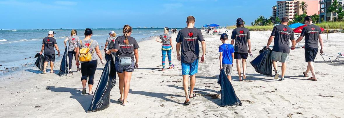 People on beach cleaning up litter