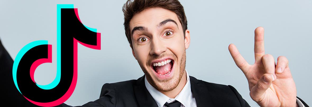 Photo of a business man make a selfie video with the TikTok logo