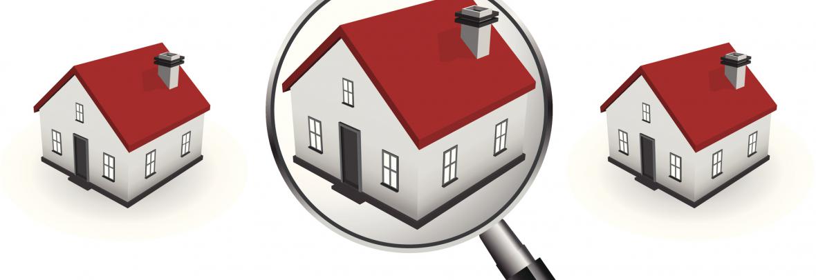 magnifying glass over middle of 3 houses with red roofs