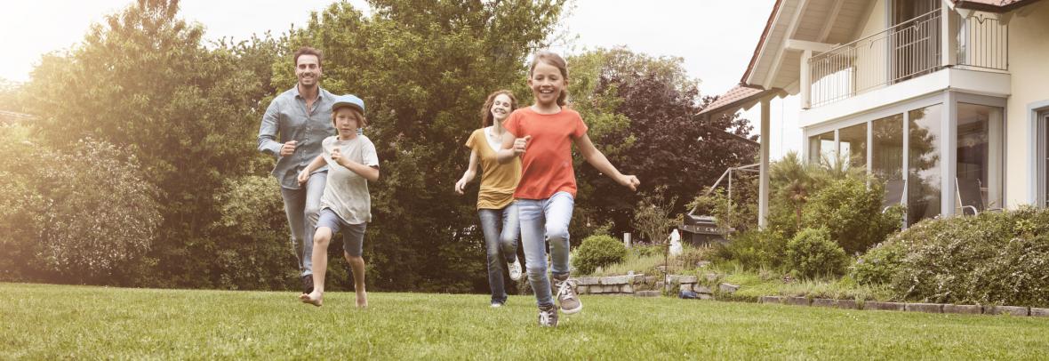 Parents and kids running in yard