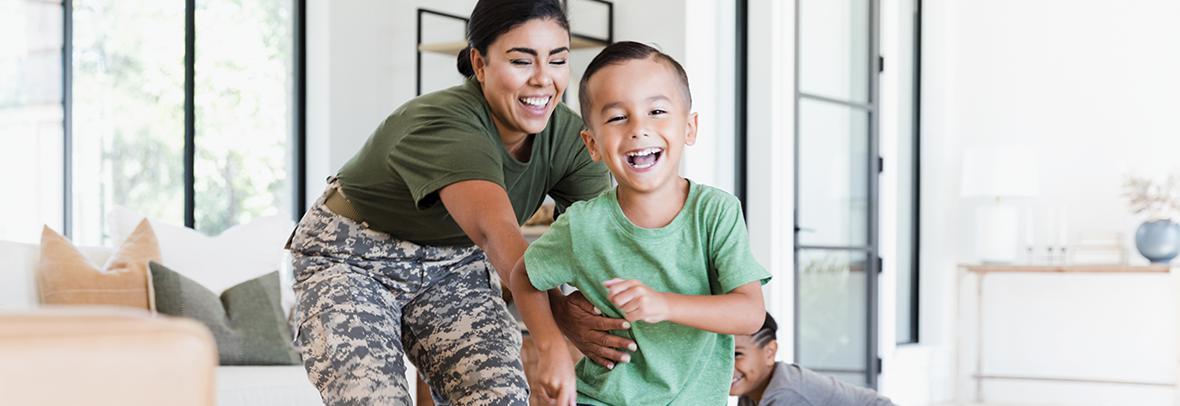 Photo of a military mom playing with her child, laughing