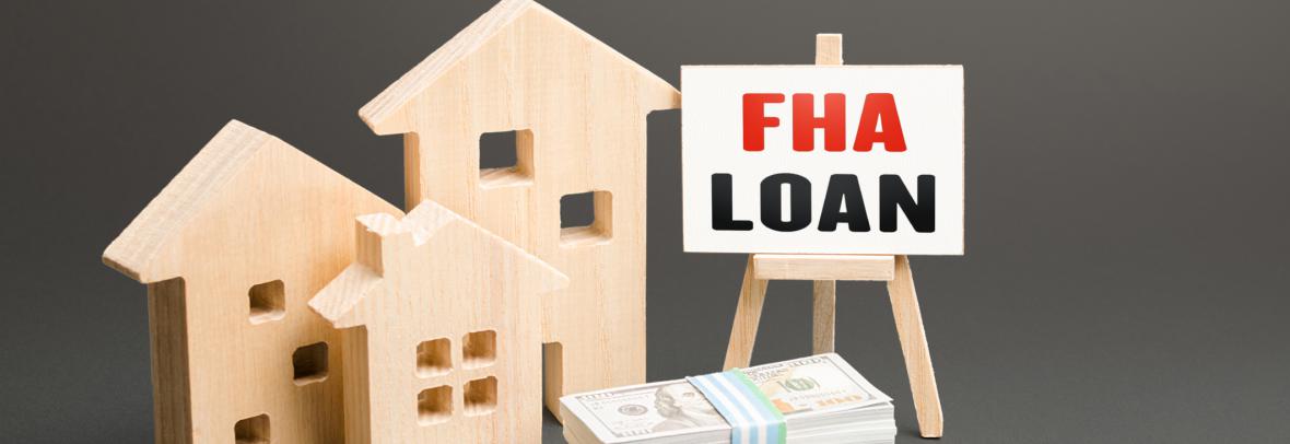 3 wooden homes, a pile of money and an FHA loan sign