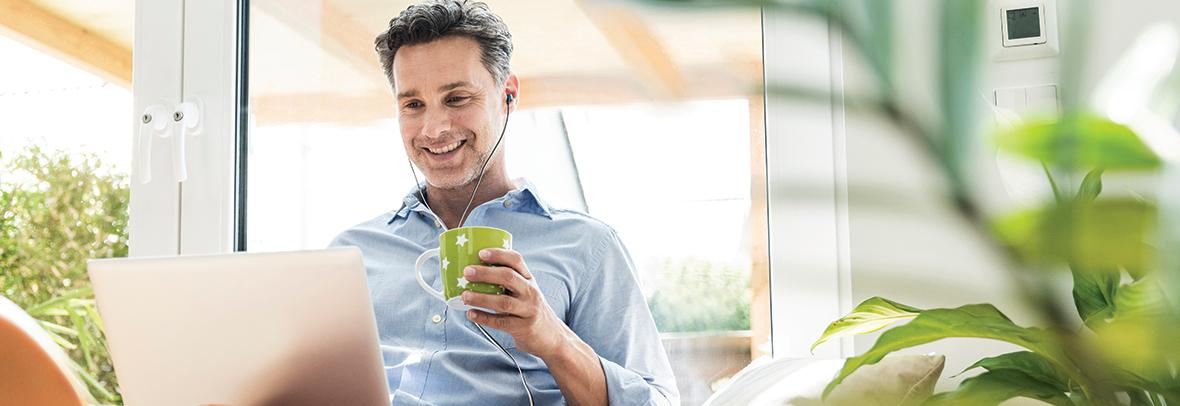 Man with headphones on listening to a podcast