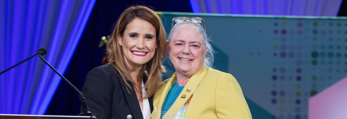 Florida Realtors President Christina Pappas presents 2021 President Cheryl Lambert with the 2022 Realtor of the Year award