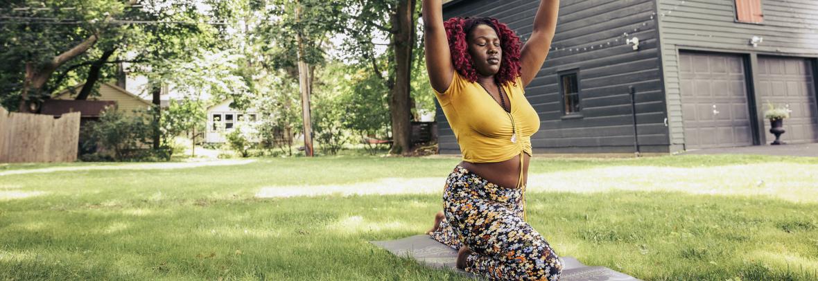 Woman doing yoga in backyard