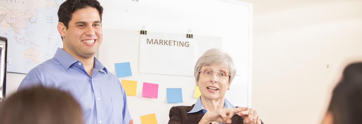 A woman and a man using sign language to talk to a couple