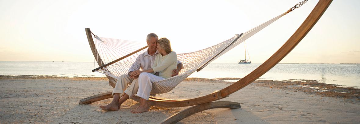 Photo of a senior couple on a hammock on the beach