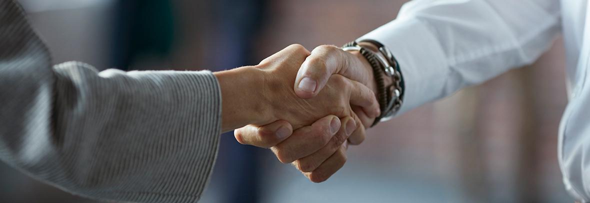 Photo of two business people shaking hands