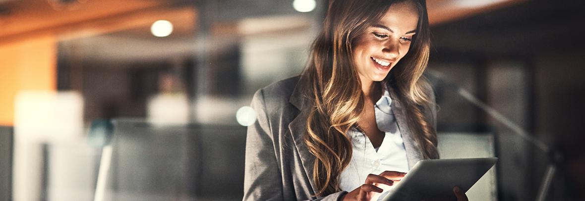 Photo of a business using a tablet and smiling