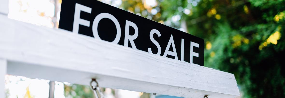 For Sale Sign in Front Yard of House - stock photo Close-up of for sale rider on real estate sign post in front yard of house